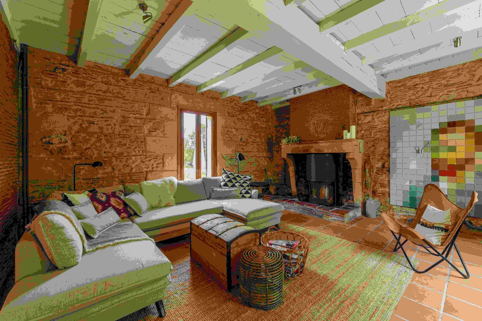 Spacious living area with woodburner in restored French farmhouse