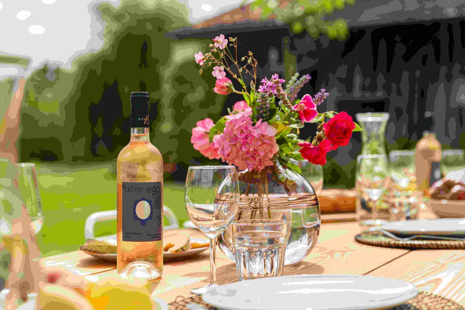 Outdoor dining table beside the pool and farmhouse